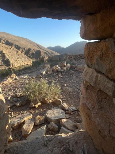 a view from a window of a rock wall at Camping, Hiking and Dhow Trip- Musandam Uncovered in Dibba
