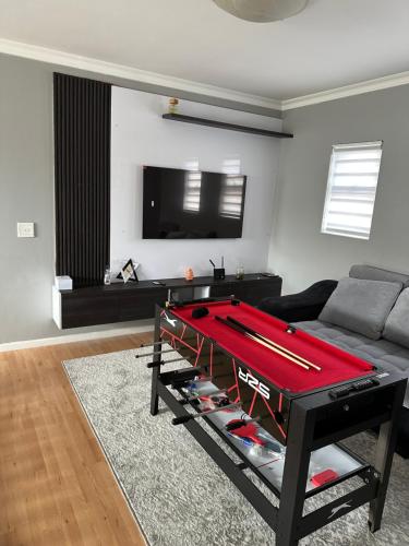 - un salon avec un billard en face d'un canapé dans l'établissement YA Eagle Wings SELF Catering Shared Apartment A, au Cap