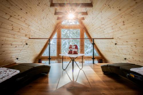a room with a window and a table with a cake on it at Pohorska Gozdna Vila in Pohorje