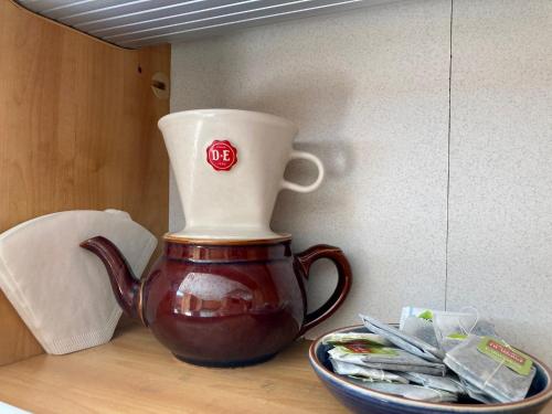 a tea pot sitting on top of a table with a bowl at Bed&Breakfast i Campingvogn in Seljord