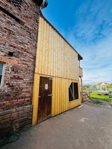 a large brick building with a large wooden door at Ferienwohnung Peters (EG) in Hünfeld