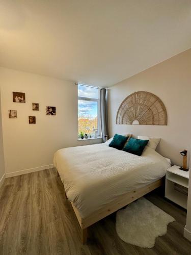 a bedroom with a large bed with a window at Le National 2 Appartement centre ville avec Parking privé in Tourcoing