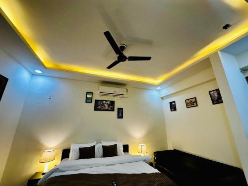 a bedroom with a ceiling fan and a bed at Oxygen Inn-Couple Friendly-Noida Sector20 in Noida
