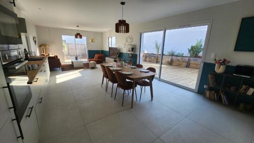 a kitchen and living room with a table and chairs at La Pétillante in Vaux-sur-Mer