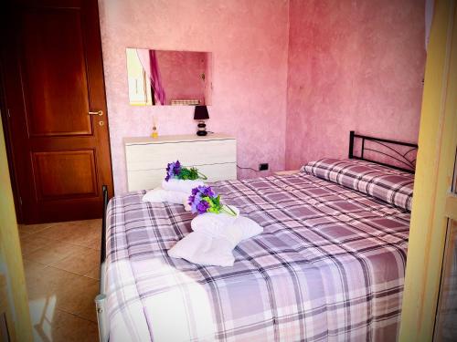 a bedroom with two beds with towels and flowers on it at Blef House in Fiumicino
