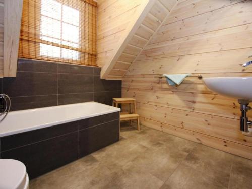 a bathroom with a bath tub and a sink at Ferienhaus, Schierke in Schierke