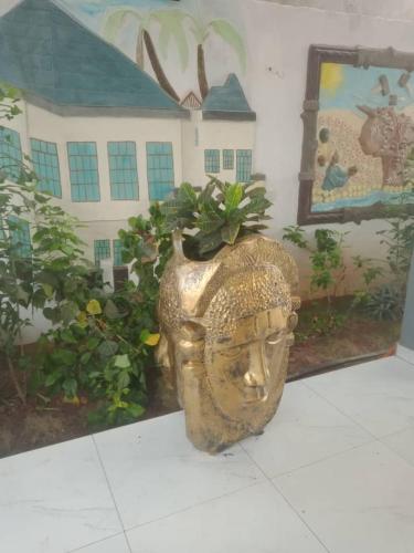 a statue of a head with a plant in it at ASVA BEACH Resort in Grand-Popo
