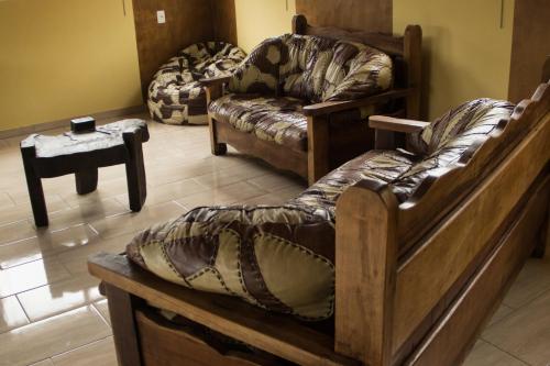 a living room with two couches and a couch at Pousada Colonetti in Lindóia