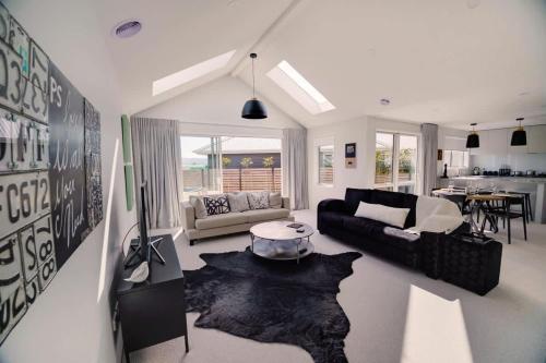 a living room with a couch and a table at The Gallery in Rotorua