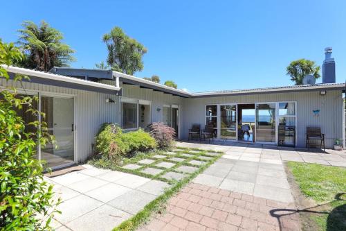 an exterior view of a house with a patio at Hannah's Bay Lakefront in Rotorua