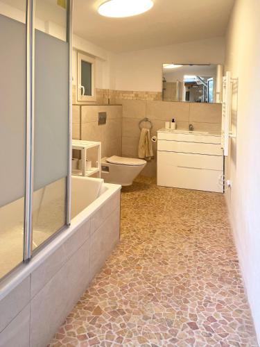 a bathroom with a tub and a toilet and a sink at Casa Mora, privater pool, Meerblick, toller Garten in Torrox