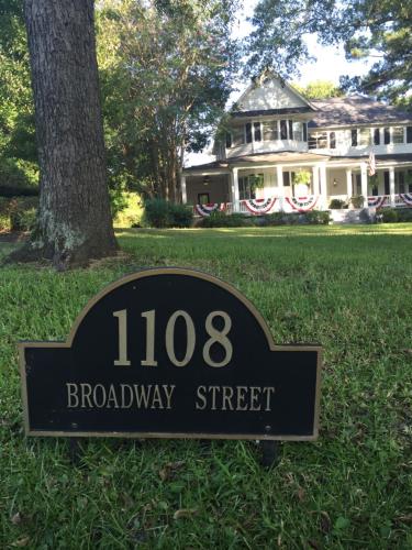 a sign in the grass in front of a house at Huffman House Bed & Breakfast in Minden