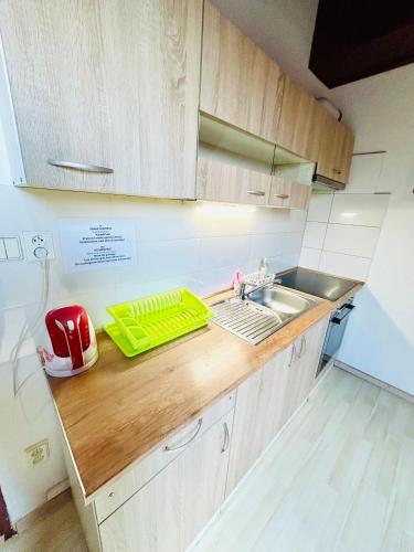 a kitchen with a sink and a counter top at Villa Apartments with Free Parking Prague 5 in Prague
