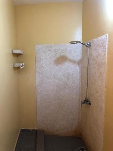 a shower stall in a bathroom with a shower at La Maison tout confort au bord de la mer in Niaga