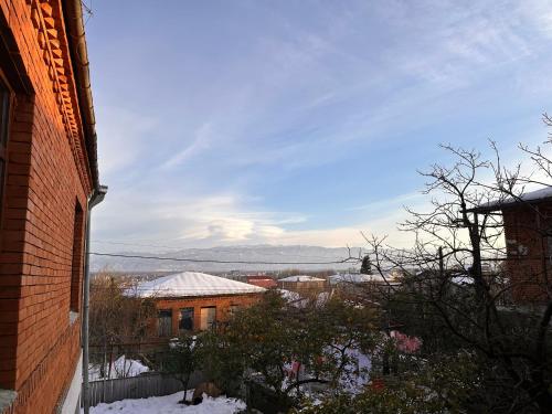 a view of a city in the snow from a building at Cozy Cove in Kutaisi