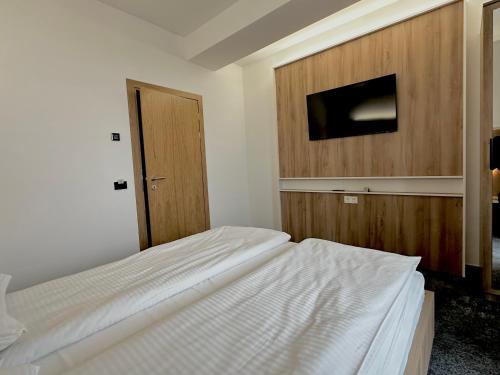 a bedroom with two beds and a flat screen tv at Apartment OneClickRenrt Oasis in Chişinău