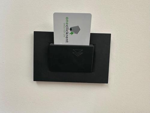 a black card holder with a laptop in it at Apartment OneClickRenrt Oasis in Chişinău