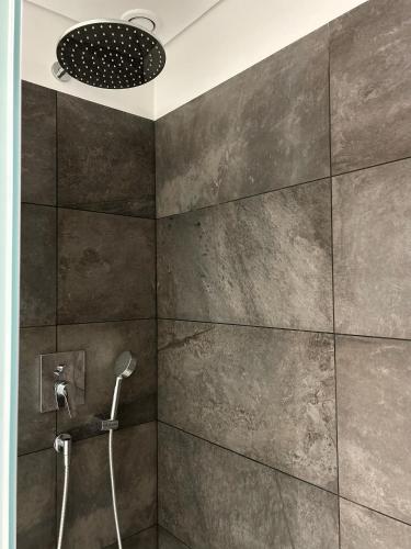 a bathroom with a shower with a shower head at Boulevard Lisbon Prime Suite in Lisbon