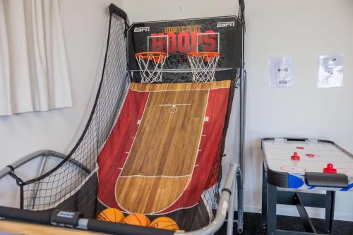 un campo da basket con rete e canestro di Cozy Lake Retreat Lake Views & Amazing Games Room a Hamurana