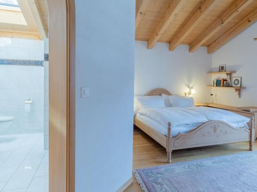 a bedroom with a bed and a walk in shower at Orion - Luxuriöse Duplex Wohnung in Grindelwald in Grindelwald