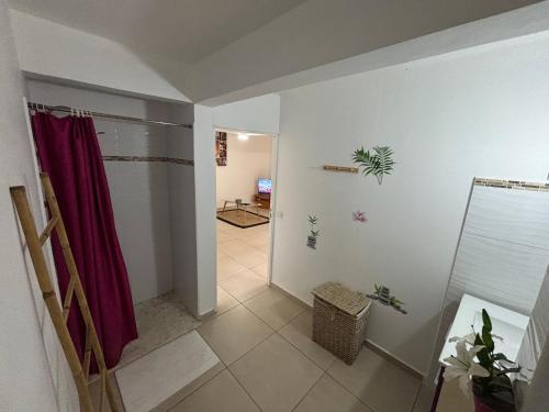 a hallway with a red shower curtain in a room at Villa Corail Les Abymes in Les Abymes