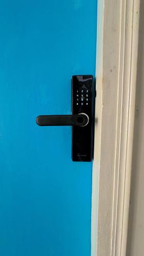 a black door handle on a blue door at Patna Backpackers in Patna