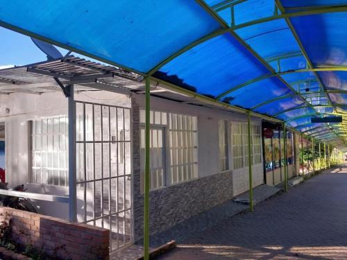 a building with a blue roof with windows on it at Apto en la represa de prado, Tolima in Boquerón de Tena