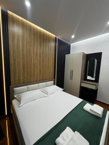 a bedroom with a large bed with two towels on it at Apartments Costa Azzurra in Velipojë