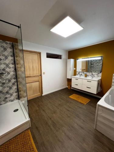 a large bathroom with a shower and a sink at Le Nido in Orville
