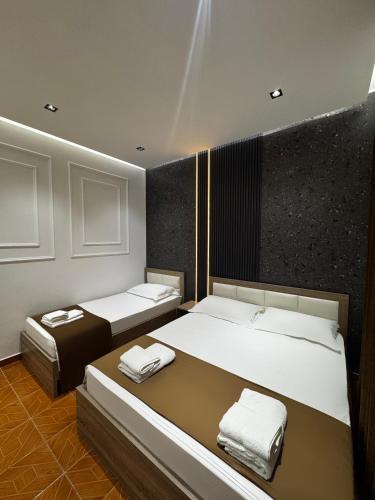 two beds in a room with two bedsvisor at Apartments Costa Azzurra in Velipojë