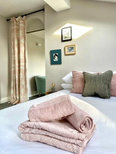a bedroom with a bed with two towels on it at The Old Stables, The River Severn, Shrewsbury in Shrewsbury
