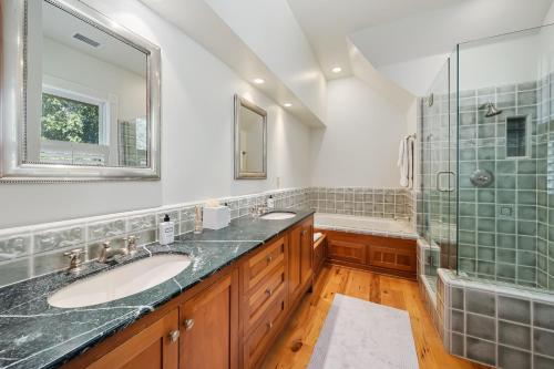 a bathroom with two sinks and a shower at 1800s Victorian Home- Halter Ranch in Adelaida