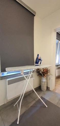 a room with a bed with a table at DM apartman Beograd in Vračar (historical)