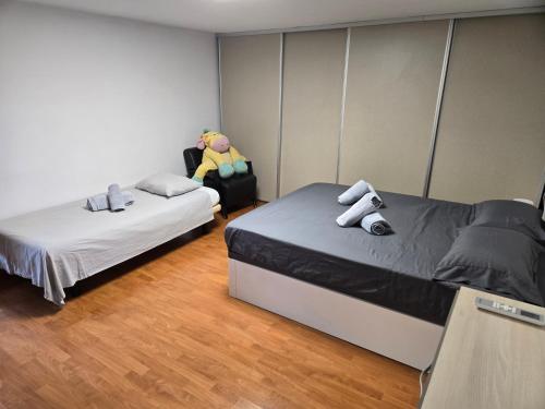 a room with two beds and a chair in it at Chalet con piscina LUA HOME in Manises
