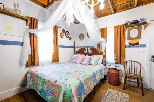 a bedroom with a bed with a colorful bedspread at Cape Charles Tiny Livin' in Cape Charles