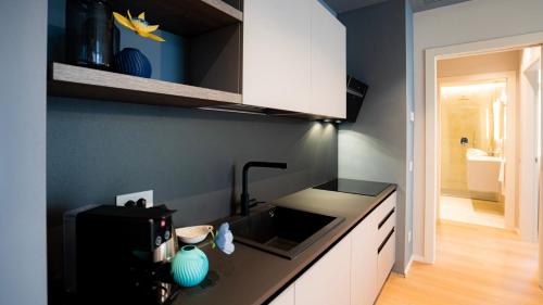 a kitchen with a sink and a counter top at The Corner Bergamo Elegant Apartments in Bergamo