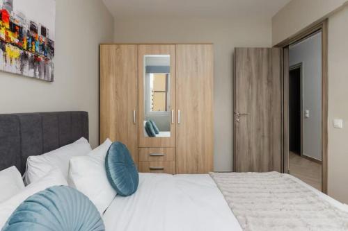 a bedroom with a large white bed with blue pillows at Ladadika Urban Apartment Two Bedroom in Thessaloniki