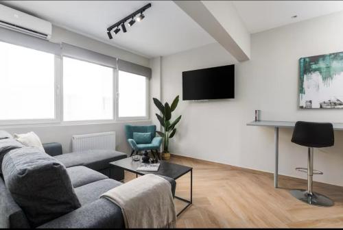 a living room with a couch and a flat screen tv at Ladadika Urban Apartment Two Bedroom in Thessaloniki