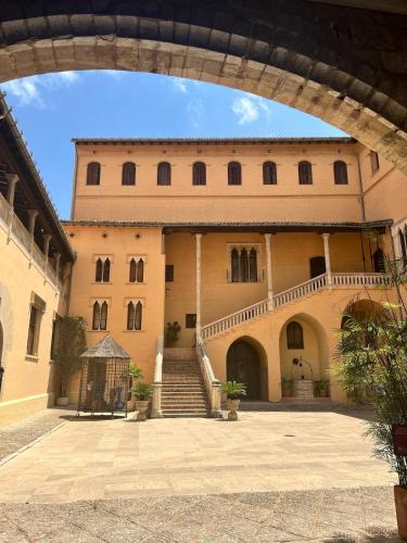 a large building with a staircase in front of it at Apartamentos de la Casa Ducal in Gandía