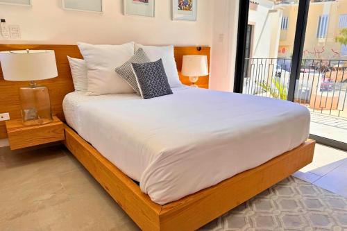 a bed with two pillows on it in a bedroom at Casa Gallo, Heated Pool, Exclusive Beach & Great Location in Cabo San Lucas