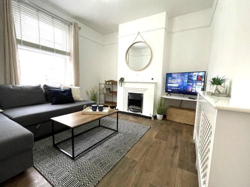 a living room with a couch and a table at Shoreside - Beach Family Home in Exmouth