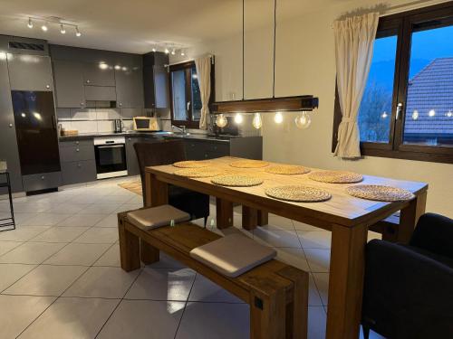 a kitchen with a wooden table and a dining room at Casa14 - Swiss houses in Steffisburg