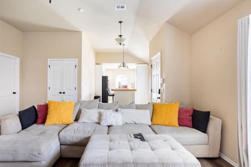 a living room with a large couch with colorful pillows at Cheerful 3 Bdrm space, 2 bath!. You gotta love it! in Oklahoma City