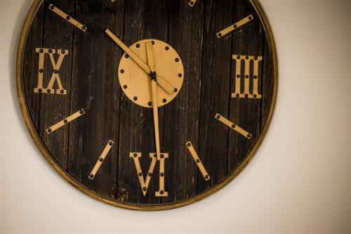 a wooden clock is hanging on a wall at Cape Charles Tiny Livin' in Cape Charles
