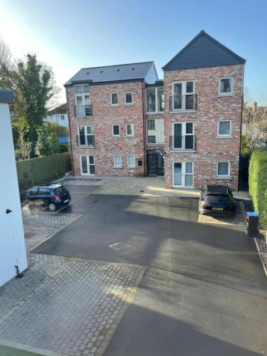 a parking lot in front of a brick building at 5 Star - The Ulsterville Residences - Free On-site Parking in Belfast