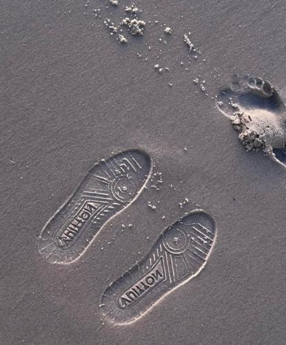 a pair of footprints in the sand on the beach at Triple A visitors in Kilindoni
