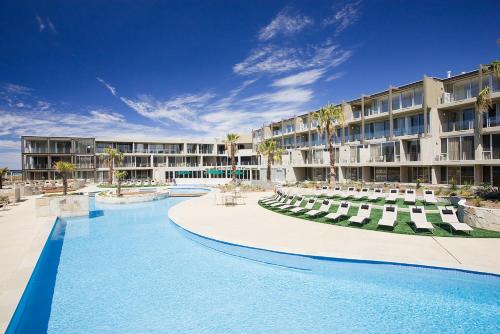 a resort with a swimming pool and a hotel at Wyndham Resort Torquay in Torquay