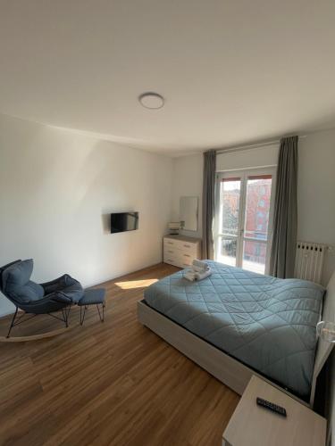 a bedroom with a bed and a chair and a window at Soleo guesthouse in Monza