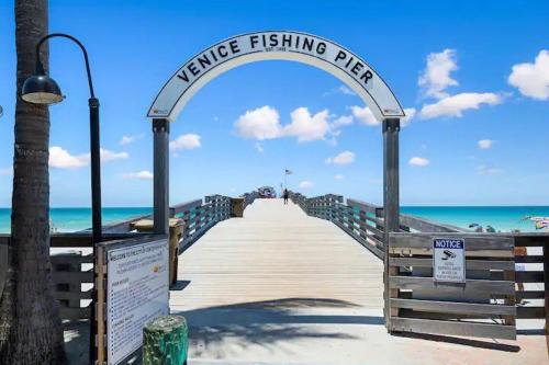 a wooden pier with an entrance to the beach at Poco Tortuga in Nokomis