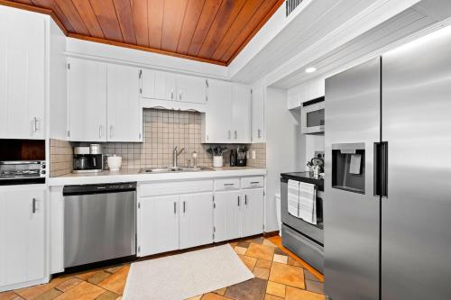 a kitchen with white cabinets and stainless steel appliances at Poco Tortuga in Nokomis